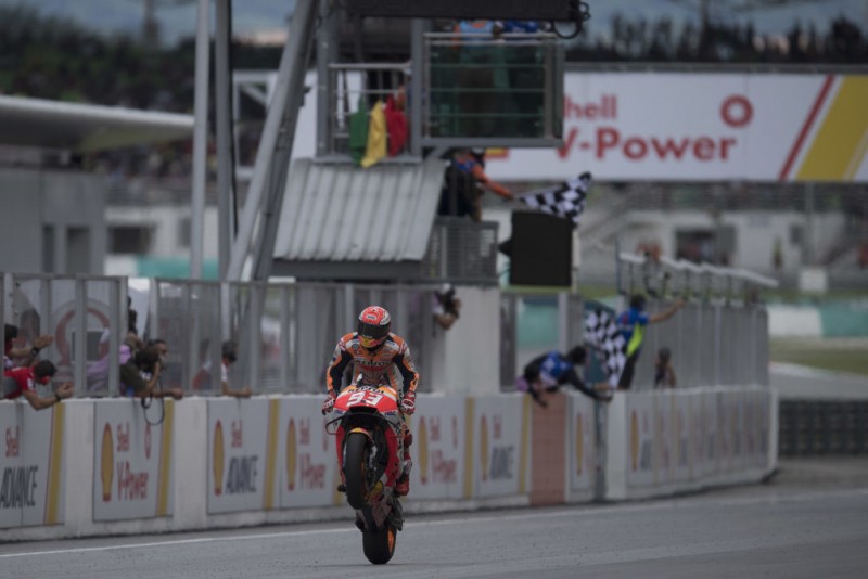 MALAYSIA - NOVEMBER 04:  Marc Marquez of Spain and Repsol Honda Team celebrates the victory under the podium at the end of the MotoGP race during the MotoGP Of Malaysia - Race at Sepang Circuit on November 4