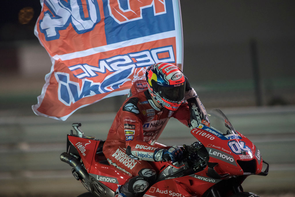 DOHA, QATAR - MARCH 10: Andrea Dovizioso of Italy and Ducati Team celebrates with flag the victory at the end of the MotoGP race during the MotoGP of Qatar - Race at Losail Circuit on March 10, 2019 in Doha, Qatar. (Photo by Mirco Lazzari gp/Getty Images)